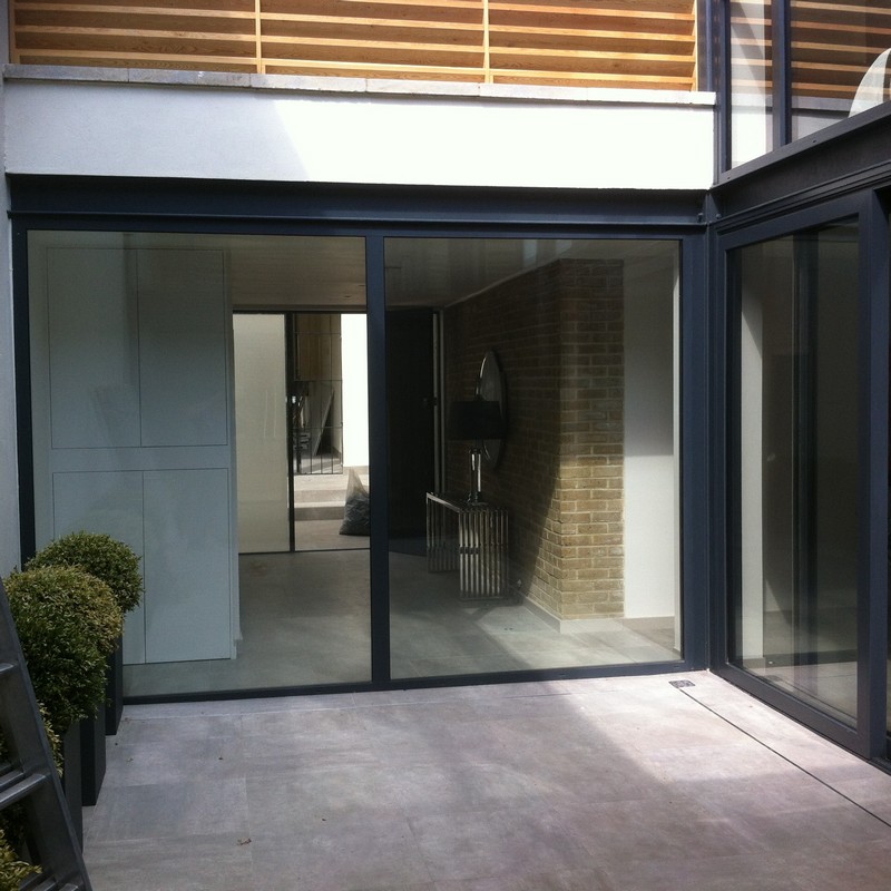 Floor-to-ceiling sliding doors opening to courtyard in Wallington